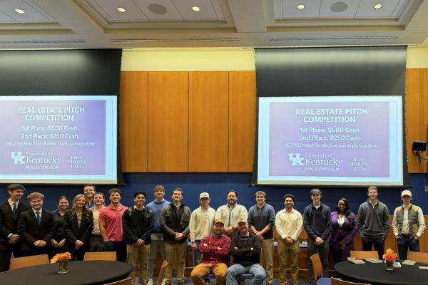 Members of the Real Estate Club pose for a group picture after the first Real Estate Pitch Competition. Shaun Sanders, director for the Center for Real Estate, stands with the group of students.