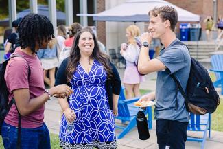 Olivia Davis speaking with two students