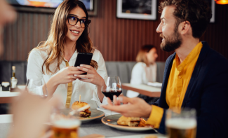 Sales associate and client having dinner in a restaurant