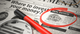 Where to Invest concept, Investments newspaper with loupe and marker.