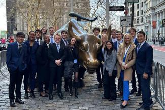 Pelissier Scholarship Students standing around the New York City Bull Statue.