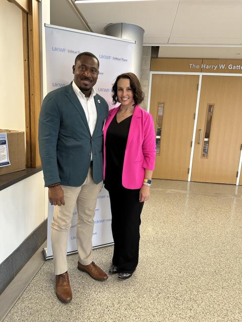 Howard Johnson, wearing a dark green blazer, and Alicia Abney, wearing a bright pink blazer, pose for a picture together outside of the ballroom at the Gatton Student Center during the annual Wildcat Forum