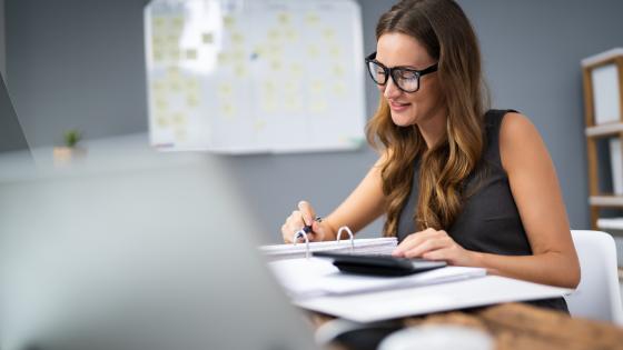 Woman writing notes in study room