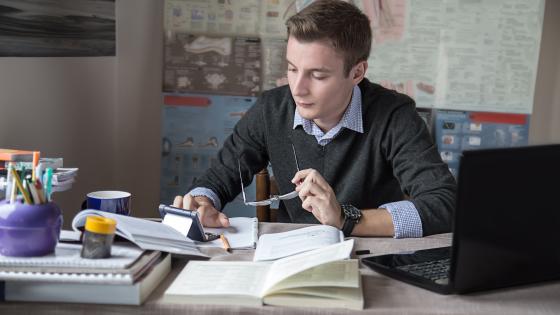 Young male student doing his homework