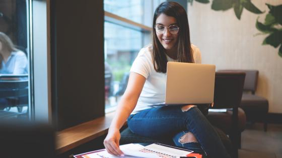 Woman smiling while reading report