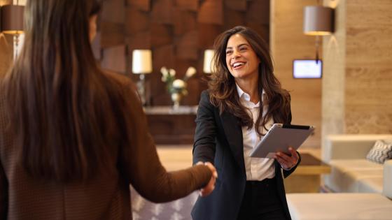 Businesswoman greeting her female business partner