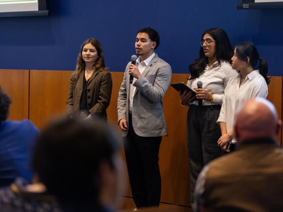 students in Gail Hoyt's Economics of Altruism course present their proposal in front of their class at the end of semester celebration