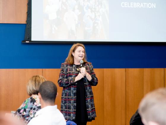 Professor Gail Hoyt stands in the front of a classroom and addresses a crowd