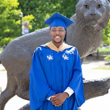 Ephraim Njeri in front of the UK Wildcat Statue