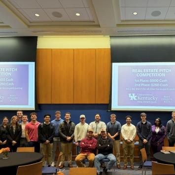 Members of the Real Estate Club pose for a group picture after the first Real Estate Pitch Competition. Shaun Sanders, director for the Center for Real Estate, stands with the group of students.
