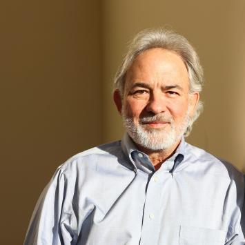 Steve Borgatti poses for a photo in a sun-drenched stairwell